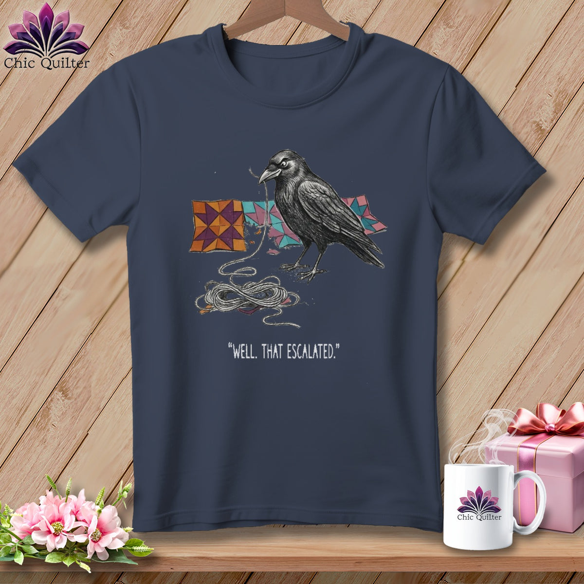 Dark blue t-shirt with a crow and quilting blocks graphic and text.