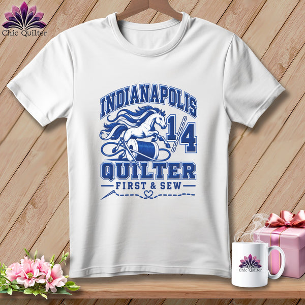 White t-shirt with blue Indianapolis Quilter text, a running horse, thread spool, and needle graphic.