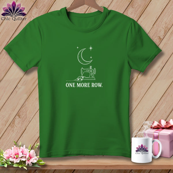 Green t-shirt with white line art of a sewing machine, moon, stars, and text "ONE MORE ROW."