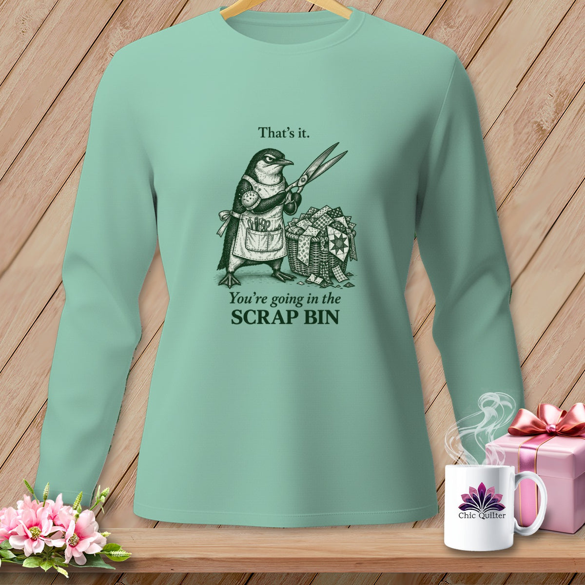 Mint long-sleeve shirt with penguin graphic saying "You're going in the SCRAP BIN".