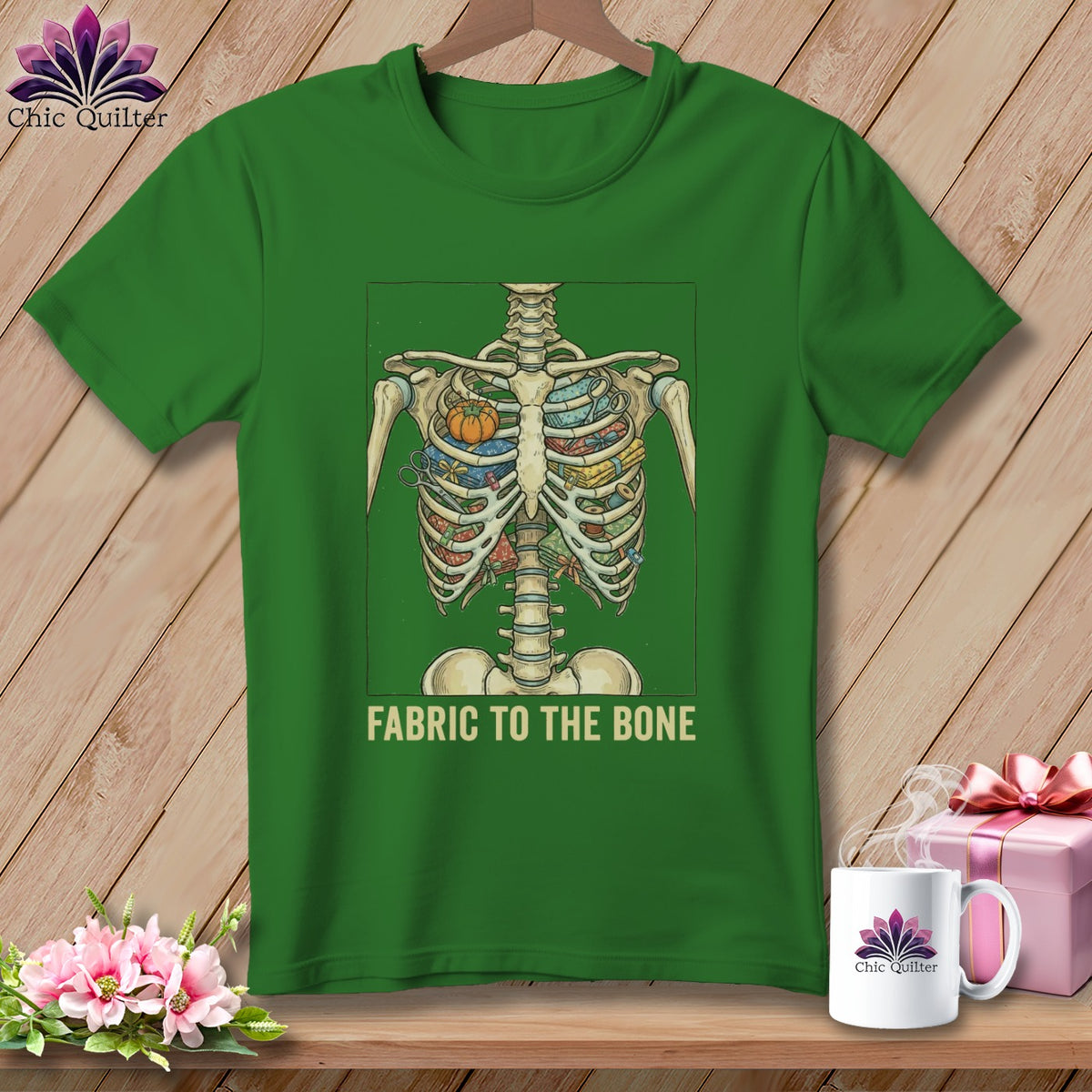 Green t-shirt with skeleton rib cage filled with fabric, sewing notions, and text "FABRIC TO THE BONE".