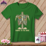 Green t-shirt with skeleton rib cage filled with fabric, sewing notions, and text 