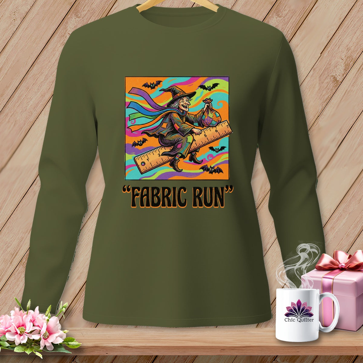 Green long-sleeve shirt with a "Fabric Run" graphic of a witch on a ruler.