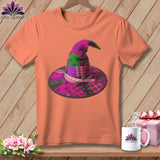 Coral t-shirt with a patchwork witch hat graphic featuring scissors and a measuring tape.
