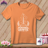 Orange t-shirt with white graphic of a seam ripper and text 
