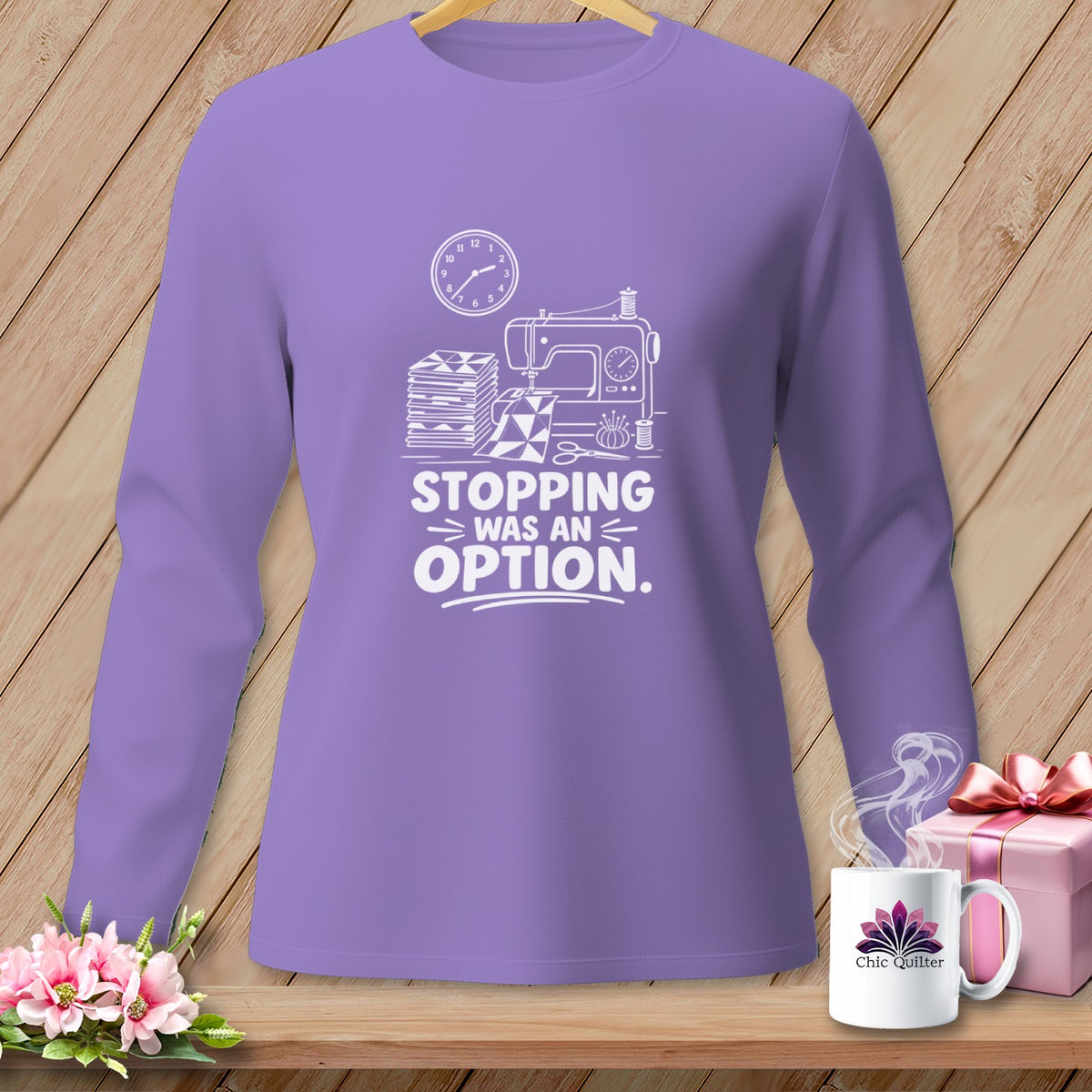 Purple long-sleeve shirt with sewing machine graphic and "Stopping Was An Option" text.