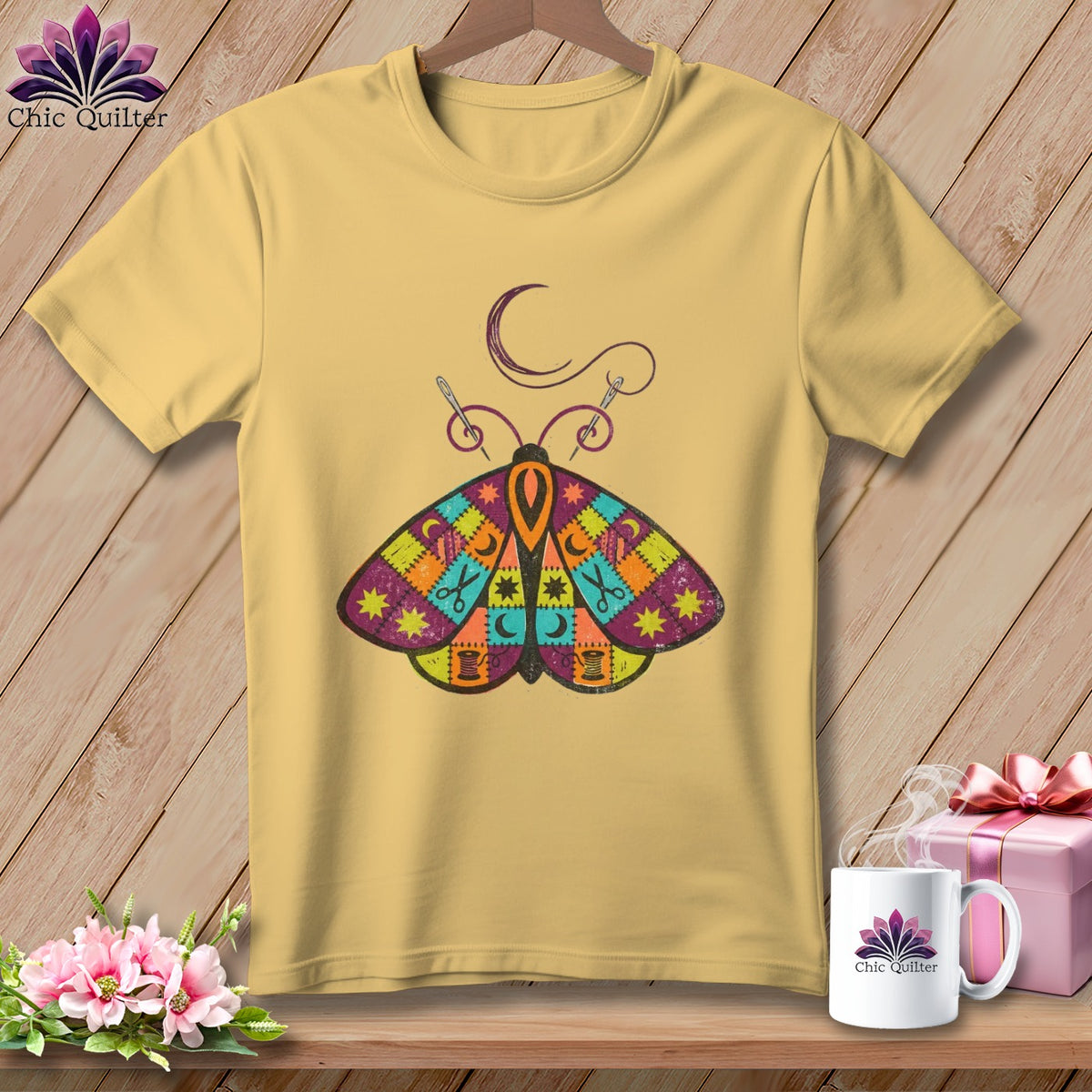 Yellow t-shirt with a colorful quilt-patterned moth graphic and sewing details.