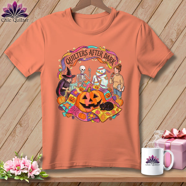 Orange t-shirt with "Quilters After Dark" Halloween graphic featuring a witch, skeleton, mummy, and pumpkins.