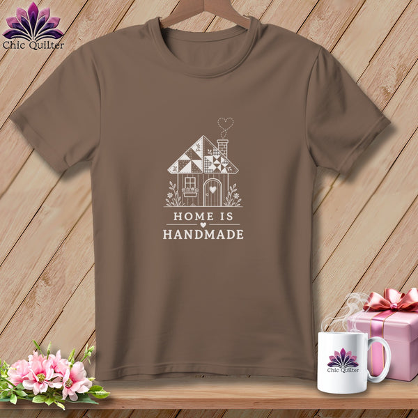 Brown t-shirt with white graphic of a quilted house, the words "HOME IS HANDMADE" and Chic Quilter logo.