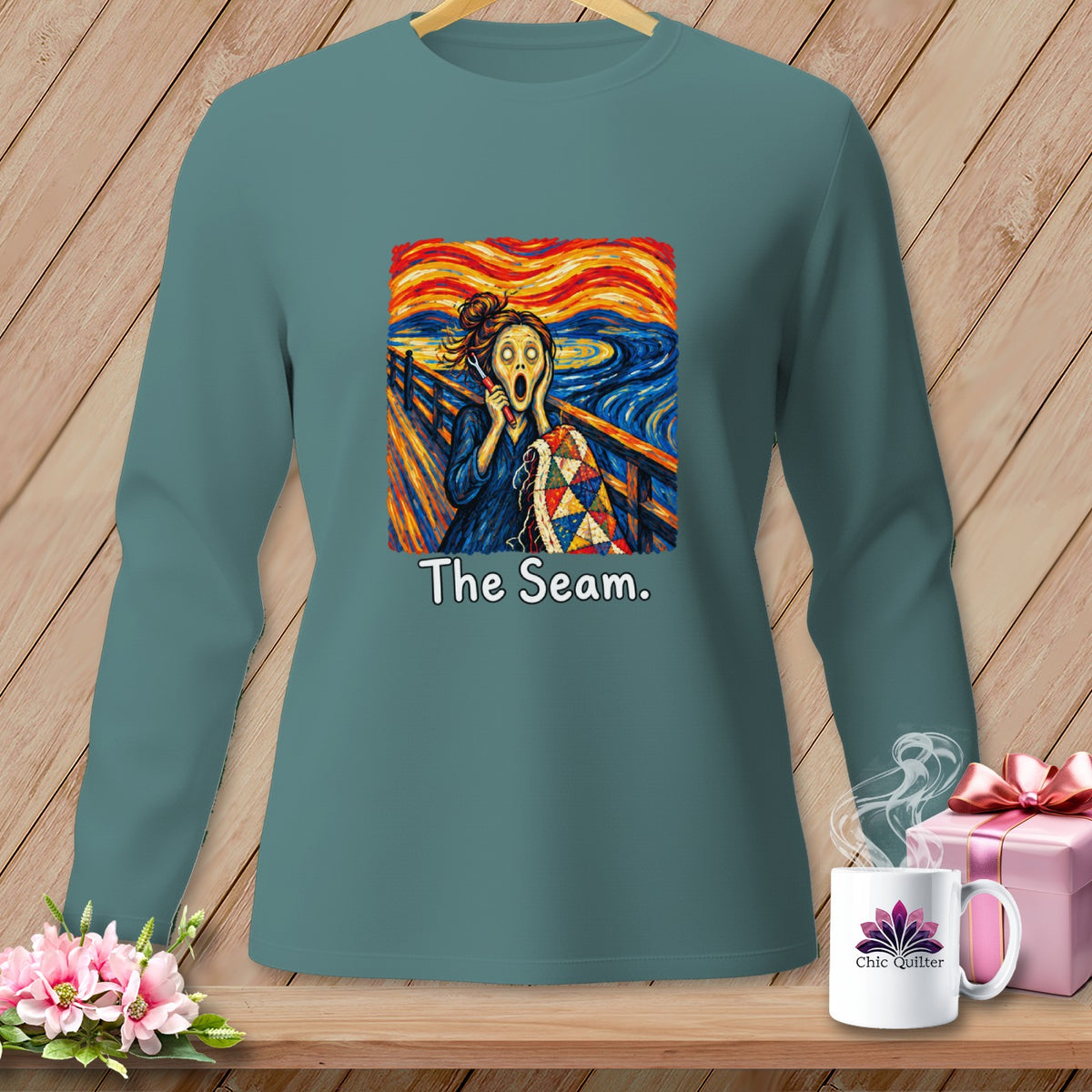 Long sleeve shirt with a graphic resembling "The Scream" holding a quilt and the text "The Seam."