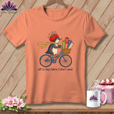 Penguin on bicycle with fabric rolls, wearing tomato hat, text 