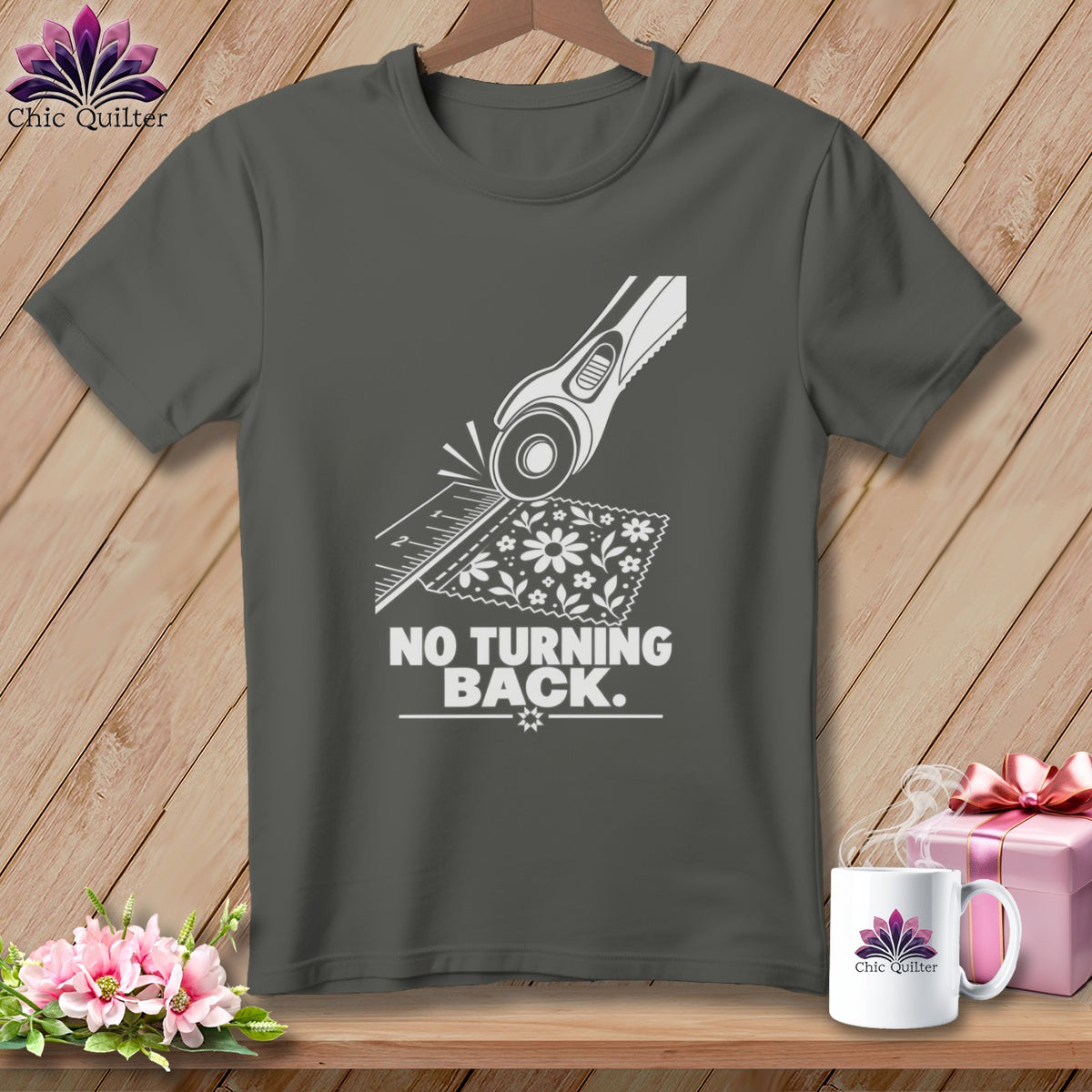 Dark gray t-shirt with white graphic of a rotary cutter and fabric, reads "NO TURNING BACK."