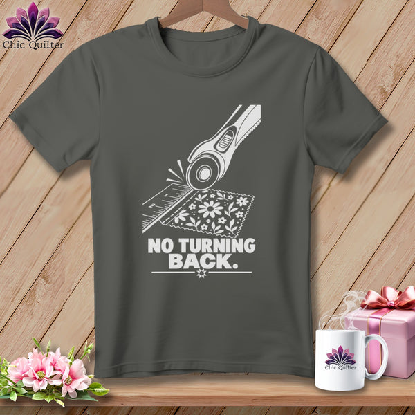 Dark gray t-shirt with white graphic of a rotary cutter and fabric, reads "NO TURNING BACK."