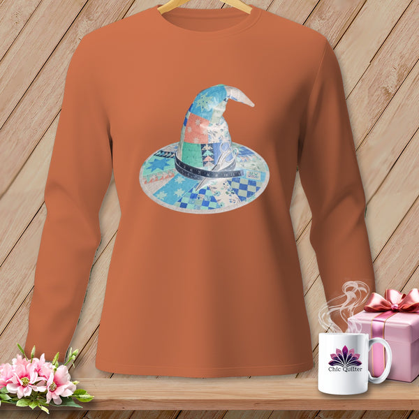 Orange long-sleeve shirt with a patchwork witch hat graphic, scissors, and "Sew Witchy" text.