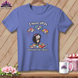 Periwinkle t-shirt featuring a cartoon hedgehog with quilt-block UFOs and the text 
