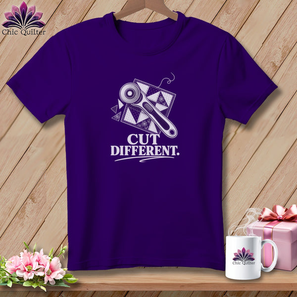 Purple t-shirt with rotary cutter, quilt squares, and "Cut Different." text.