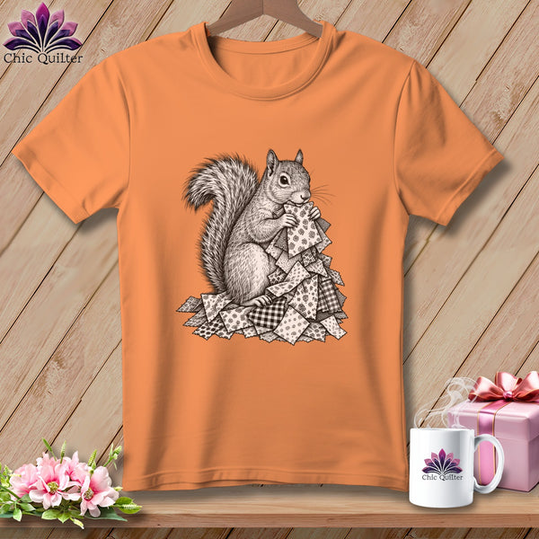 Orange crewneck t-shirt featuring a black and white sketch of a squirrel holding fabric scraps.