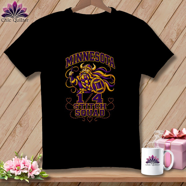 A black short-sleeved t-shirt with a purple and yellow graphic of a Viking holding a needle, bearing the text "Minnesota 1/4 Stitch Squad".