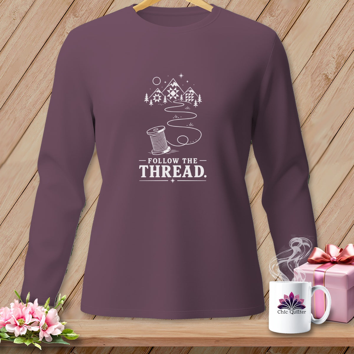 Purple long-sleeve shirt with "Follow the Thread" text and spool graphic.