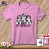 Pink t-shirt with three women peeking over a quilt, text reads 
