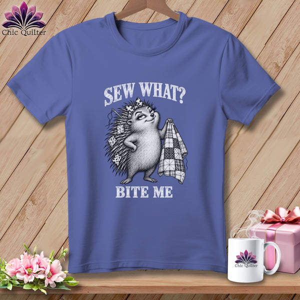 A periwinkle t-shirt features a graphic of a hedgehog holding a quilt with text reading Sew What? Bite Me.