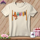 Cream t-shirt with colorful bats hanging on a clothesline with a patchwork quilt.