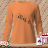 Orange long-sleeved shirt with spools of thread and buttons graphic.
