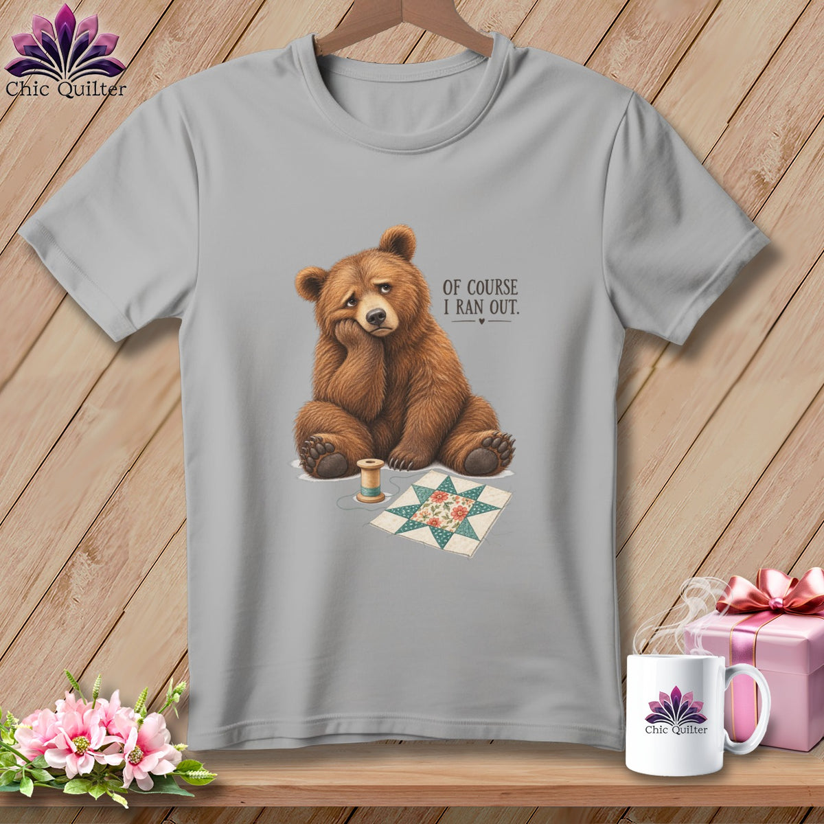 Gray t-shirt with a sad bear, spool of thread, and quilt square, text reads "OF COURSE I RAN OUT."
