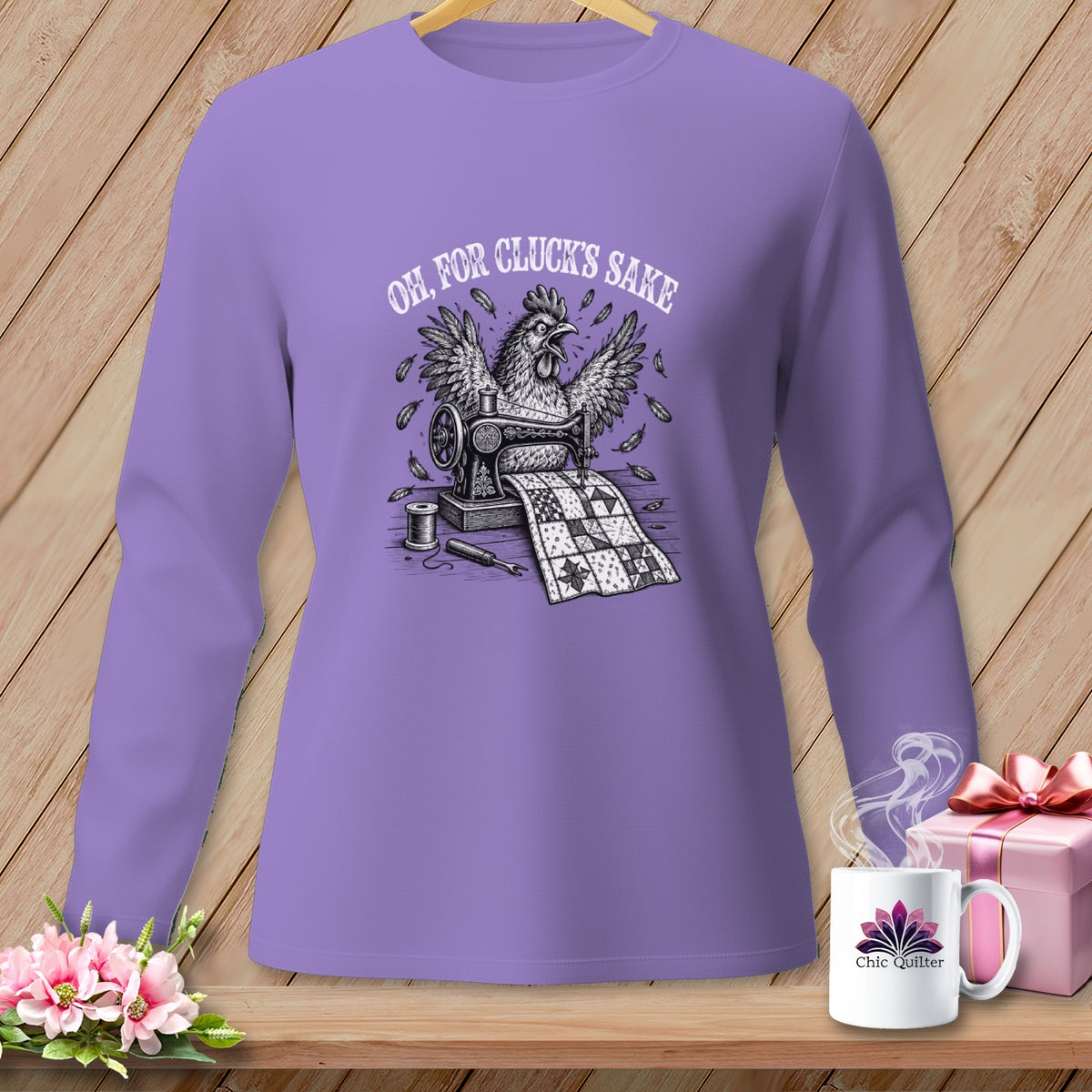 Long sleeve purple shirt with a chicken sewing a quilt and the text "Oh, for cluck's sake."