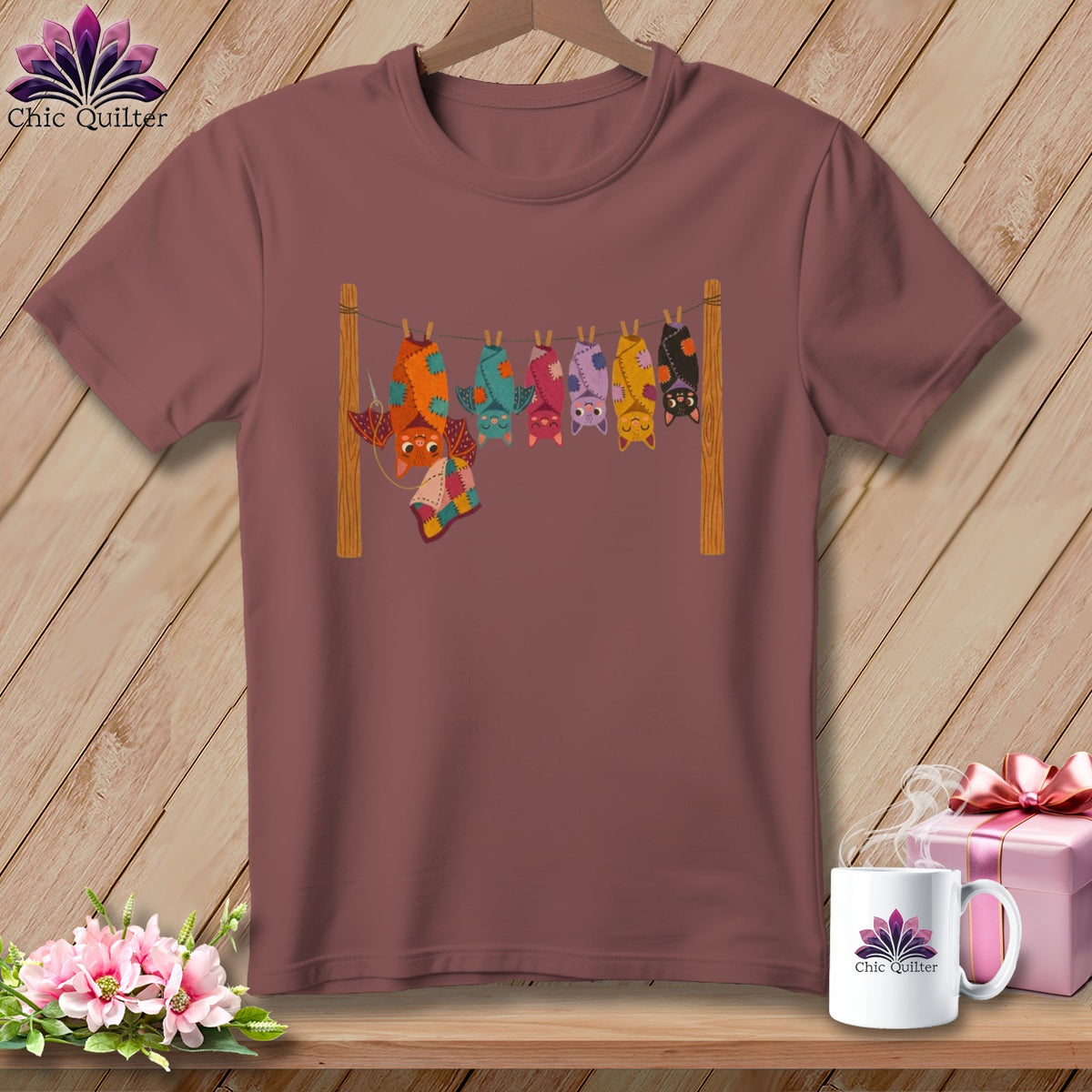 T-shirt featuring colorful quilt-like bats hanging on a clothesline.