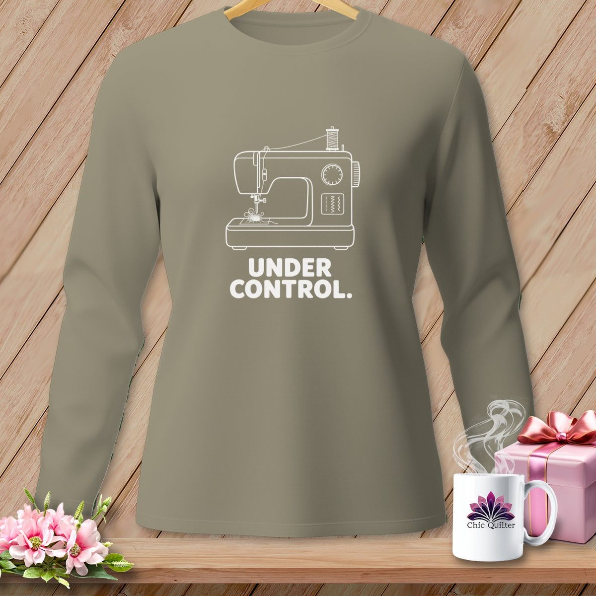 Long-sleeved taupe shirt with white sewing machine graphic and "UNDER CONTROL." text.