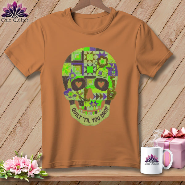 Orange t-shirt with patchwork quilt skull graphic and text "Quilt 'til you drop".