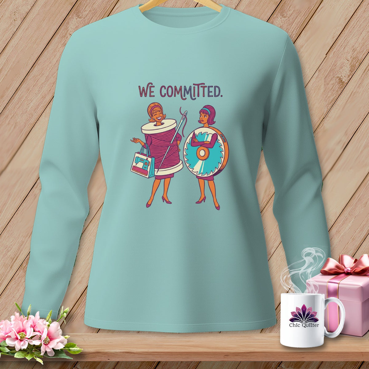Light blue long-sleeve shirt with graphic of two women and "WE COMMITTED." text.