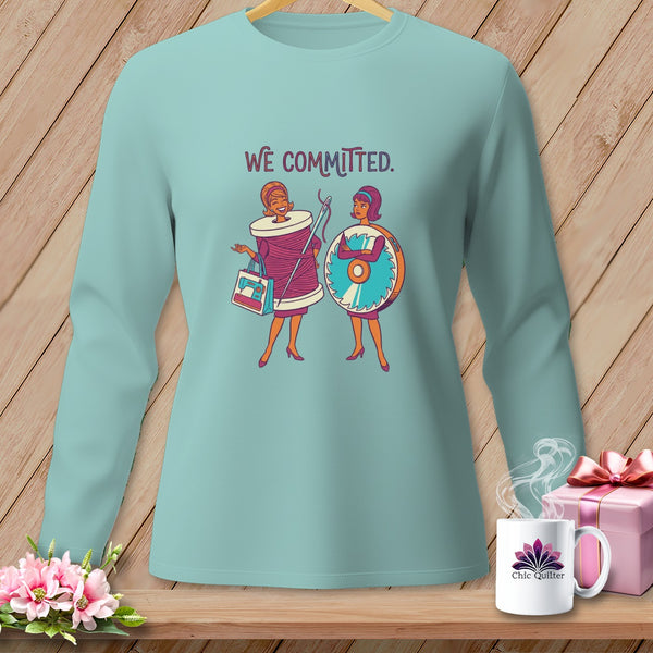 Light blue long-sleeve shirt with graphic of two women and "WE COMMITTED." text.