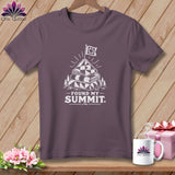 Purple t-shirt with a graphic of a stacked quilt on a mountain with a flag and text 