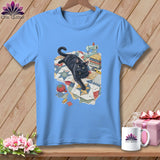 Light blue t-shirt with black cat and quilting supplies illustration.