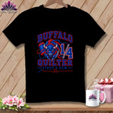 A black t-shirt hanging on a wooden background, featuring a blue and red buffalo graphic, the text BUFFALO QUILTER, and a needle and thread design.