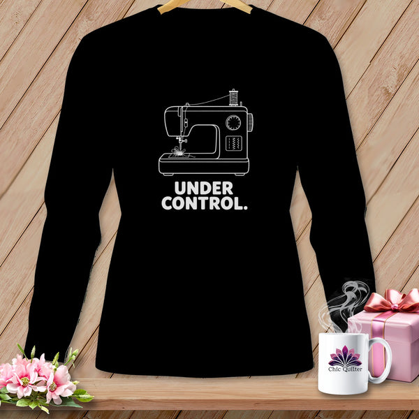 Black long-sleeved shirt with a white outline of a sewing machine and text "UNDER CONTROL."