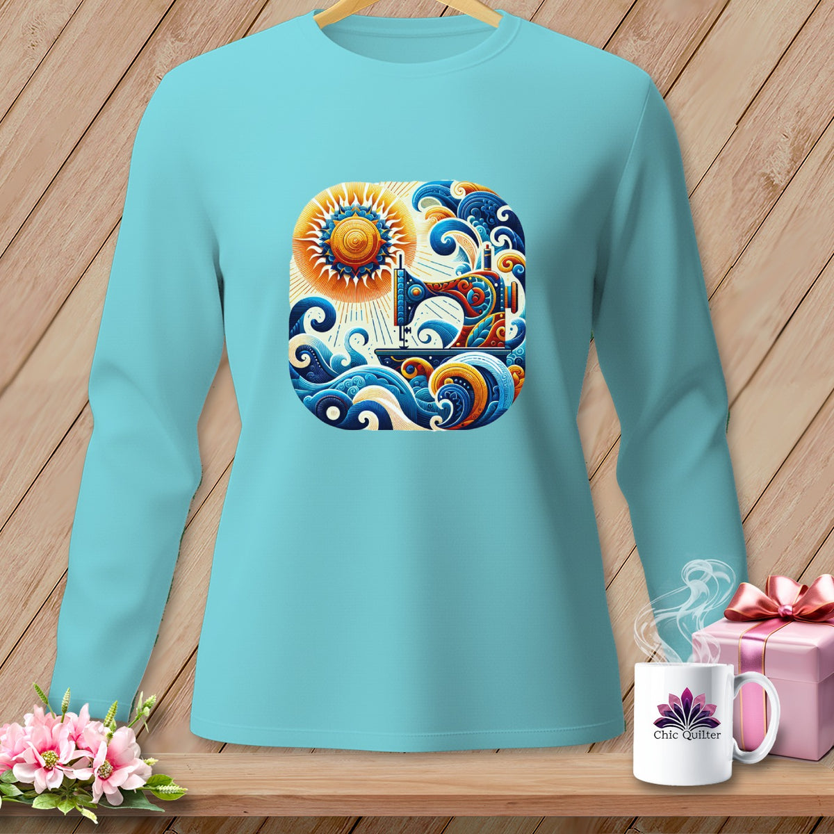 Aqua long-sleeve shirt with a colorful sewing machine and sun graphic.