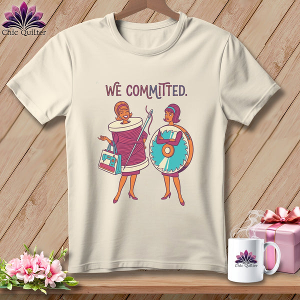 Cream t-shirt with "We Committed" text and illustrations of two women with sewing items.