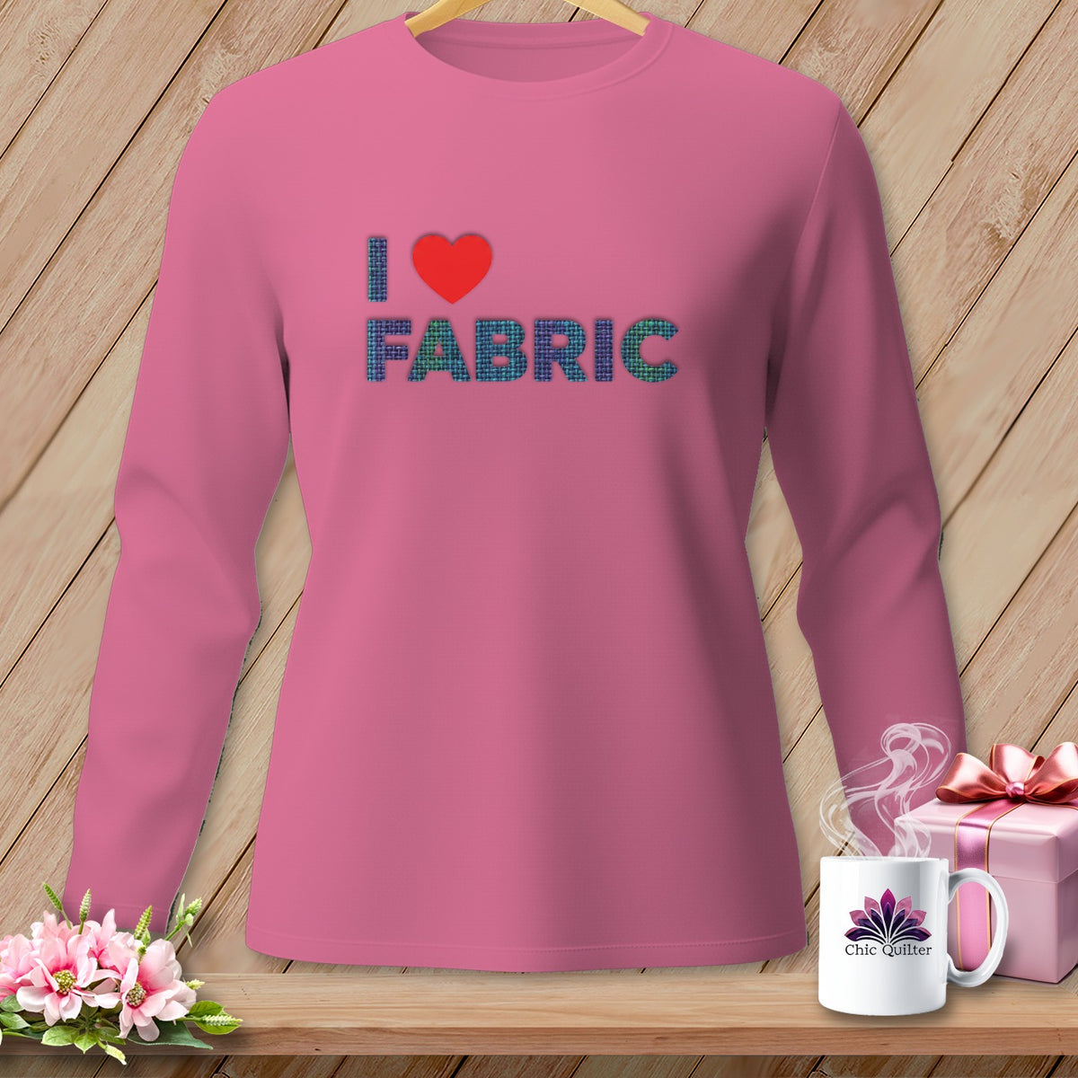 Pink long-sleeve shirt with "I ❤️ FABRIC" graphic and a Chic Quilter mug.