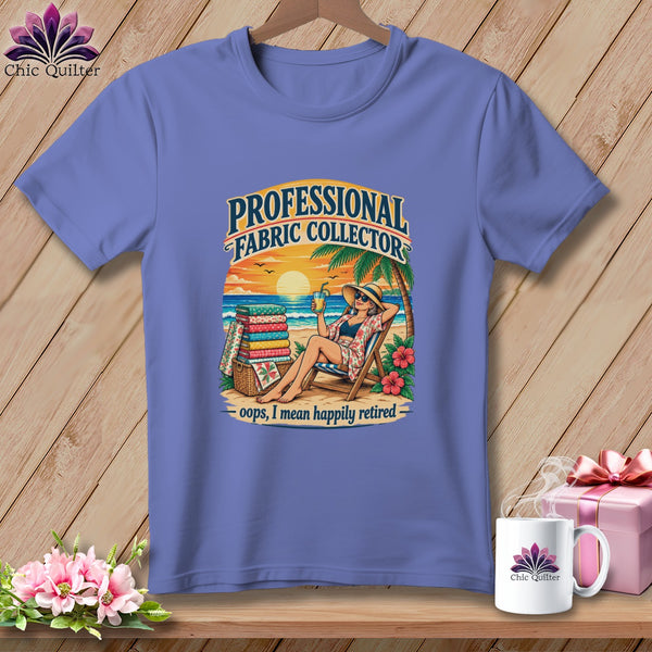 Periwinkle t-shirt featuring a beach graphic with text reading PROFESSIONAL FABRIC COLLECTOR oops, I mean happily retired.