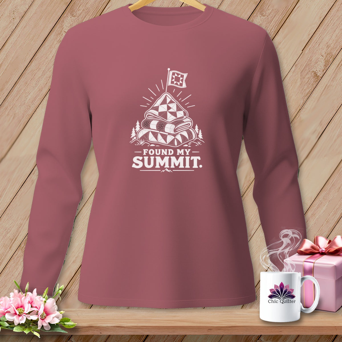 Long-sleeve shirt with white graphic of stacked quilts, flag, and text "Found My Summit."