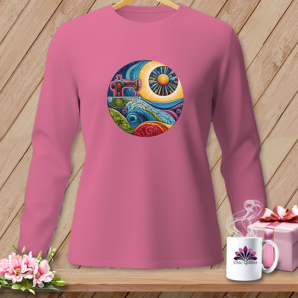 Pink long-sleeve shirt with a circular sewing machine and landscape graphic.