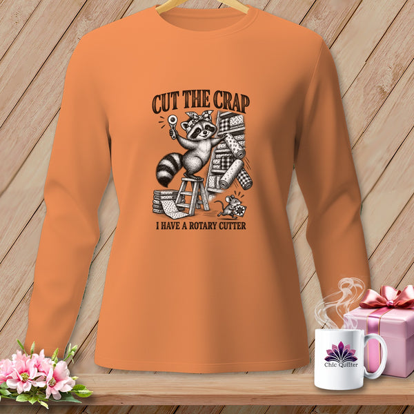 Orange long-sleeve shirt with a raccoon holding a rotary cutter and text "CUT THE CRAP I HAVE A ROTARY CUTTER".