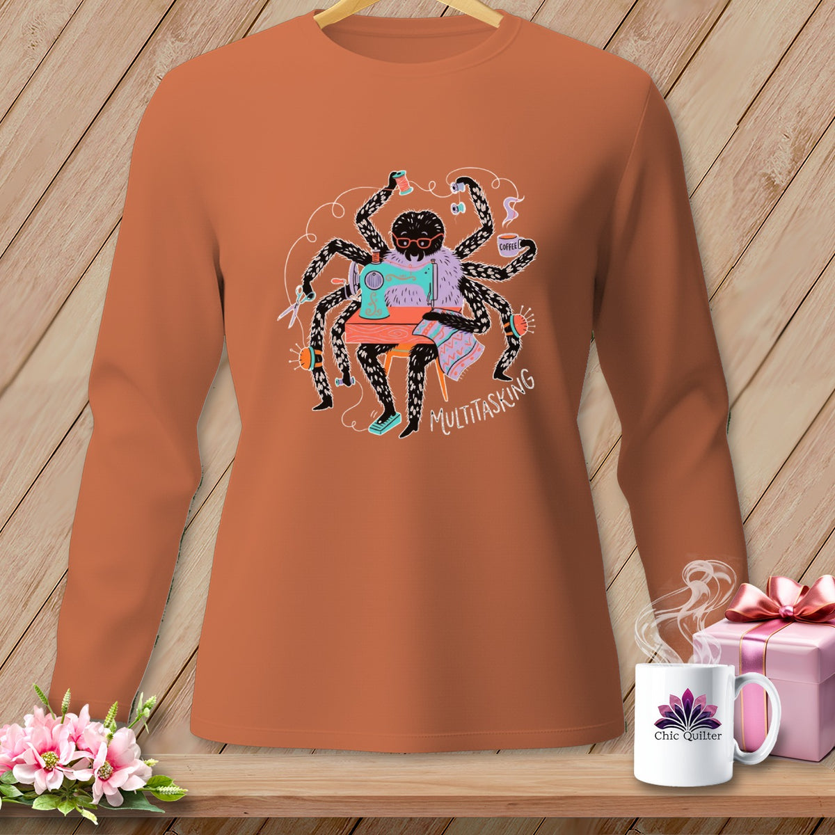 Spider sewing on a machine with "MULTITASKING" text and a coffee cup.