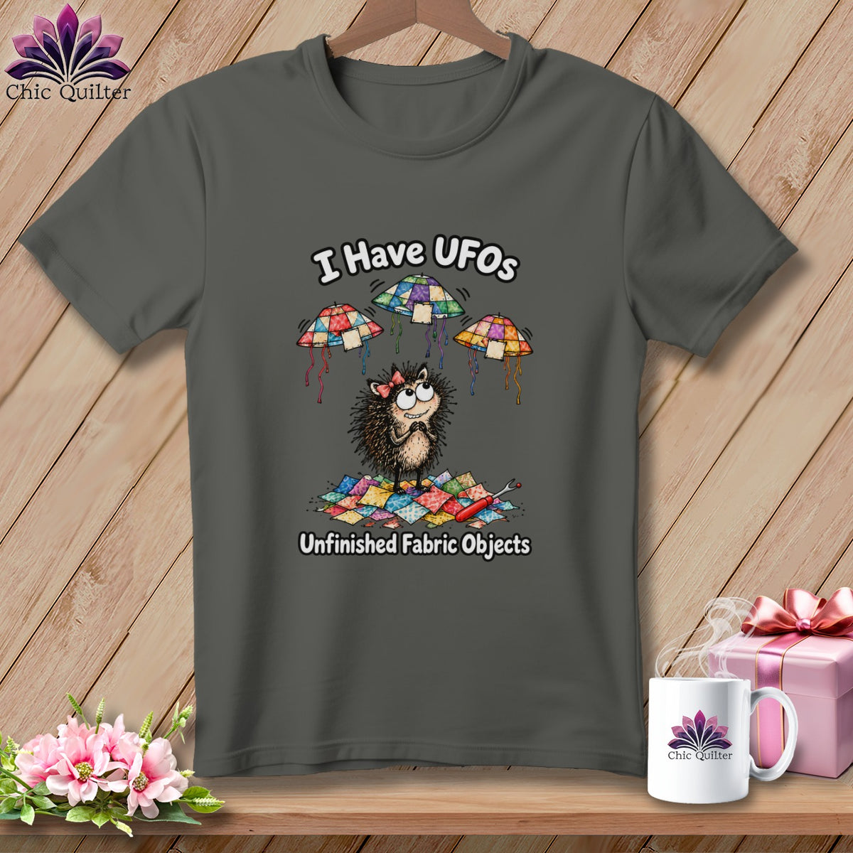 Dark gray crewneck t-shirt featuring a cartoon hedgehog, patchwork quilt UFOs, and text that reads I Have UFOs Unfinished Fabric Objects.