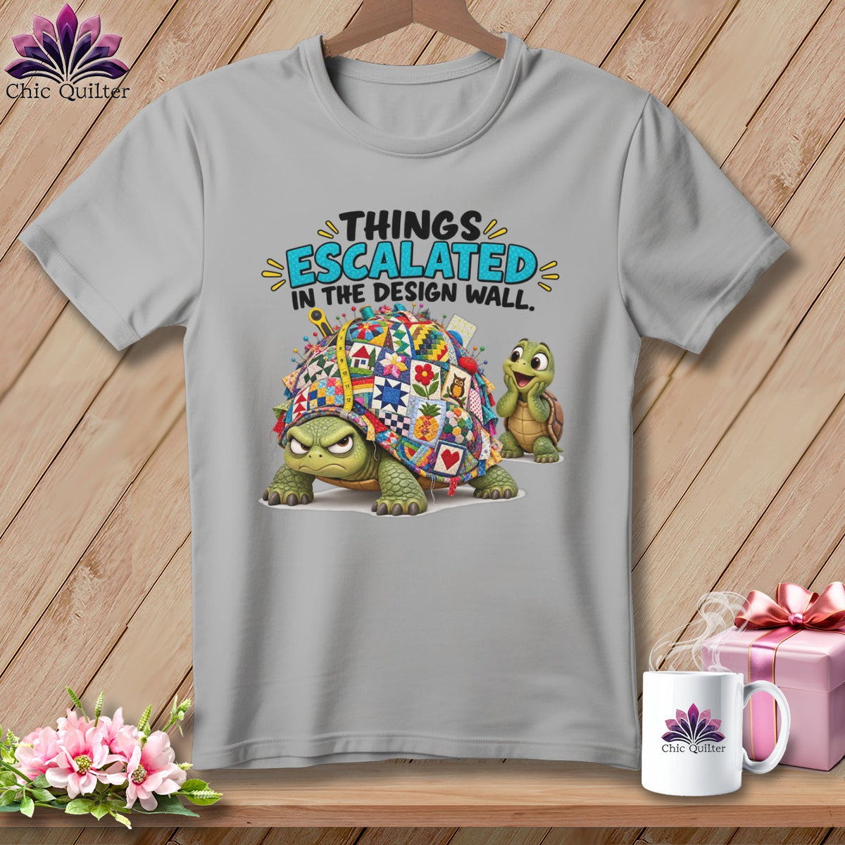 Gray t-shirt with a quilt-covered turtle and text "THINGS ESCALATED IN THE DESIGN WALL."