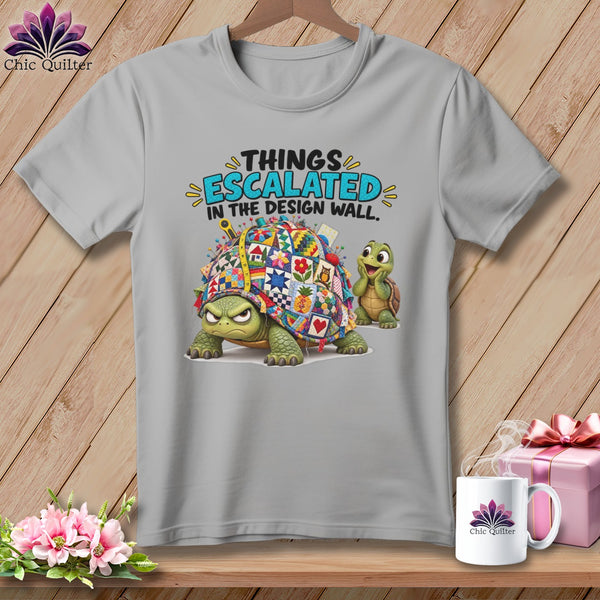 Gray t-shirt with a quilt-covered turtle and text "THINGS ESCALATED IN THE DESIGN WALL."