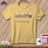 Yellow t-shirt with cartoon ghosts wearing patchwork quilts and the text 
